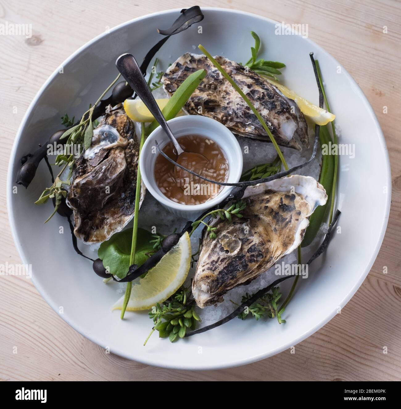 Whitstable oysters with foraged sea greens at The Red Lion pub at Stodmarsh, Kent Stock Photo