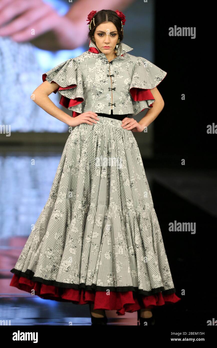 SEVILLA, SPAIN - JAN 30: Model wearing a dress from the Arpegio collection by designer Catarina Santos Rodrigues as part of the SIMOF 2020 (Photo credit: Mickael Chavet) Stock Photo