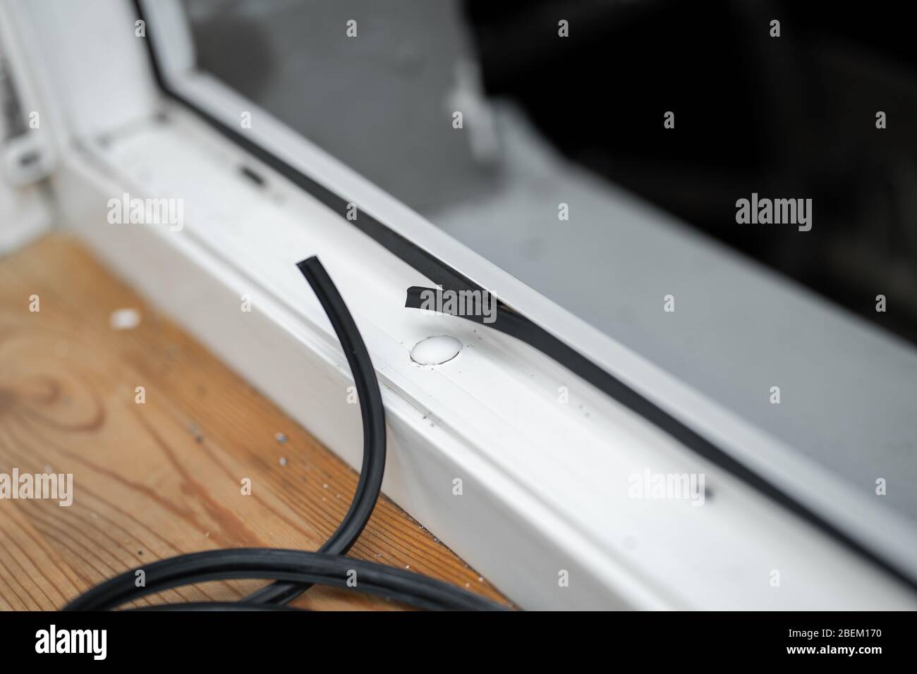 The master changes rubber seal gasket in pvc windows Stock Photo Alamy