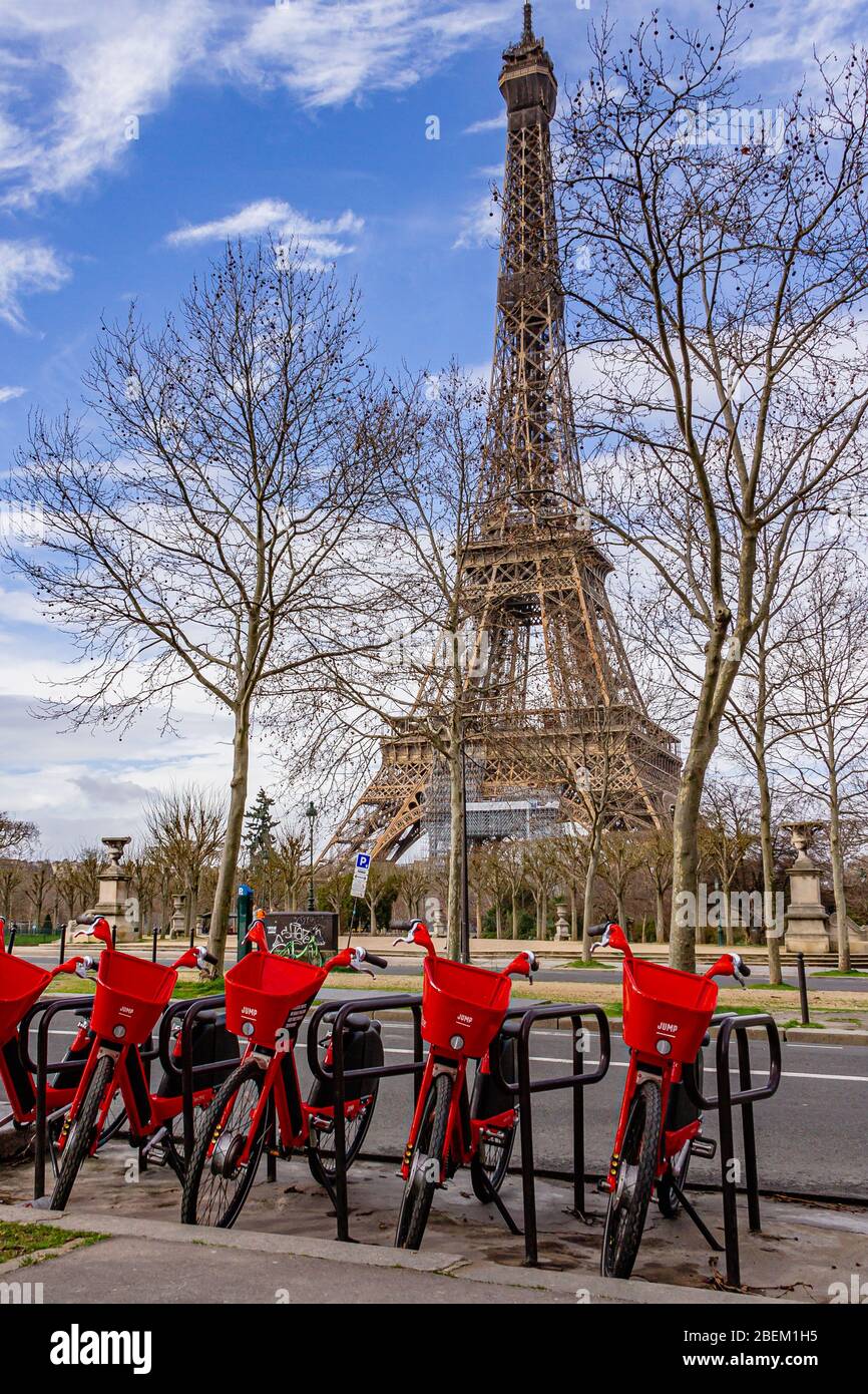 Electric hire bikes from Uber Jump parked in front of the Eiffel Tower in Paris, France. February 2020. Stock Photo