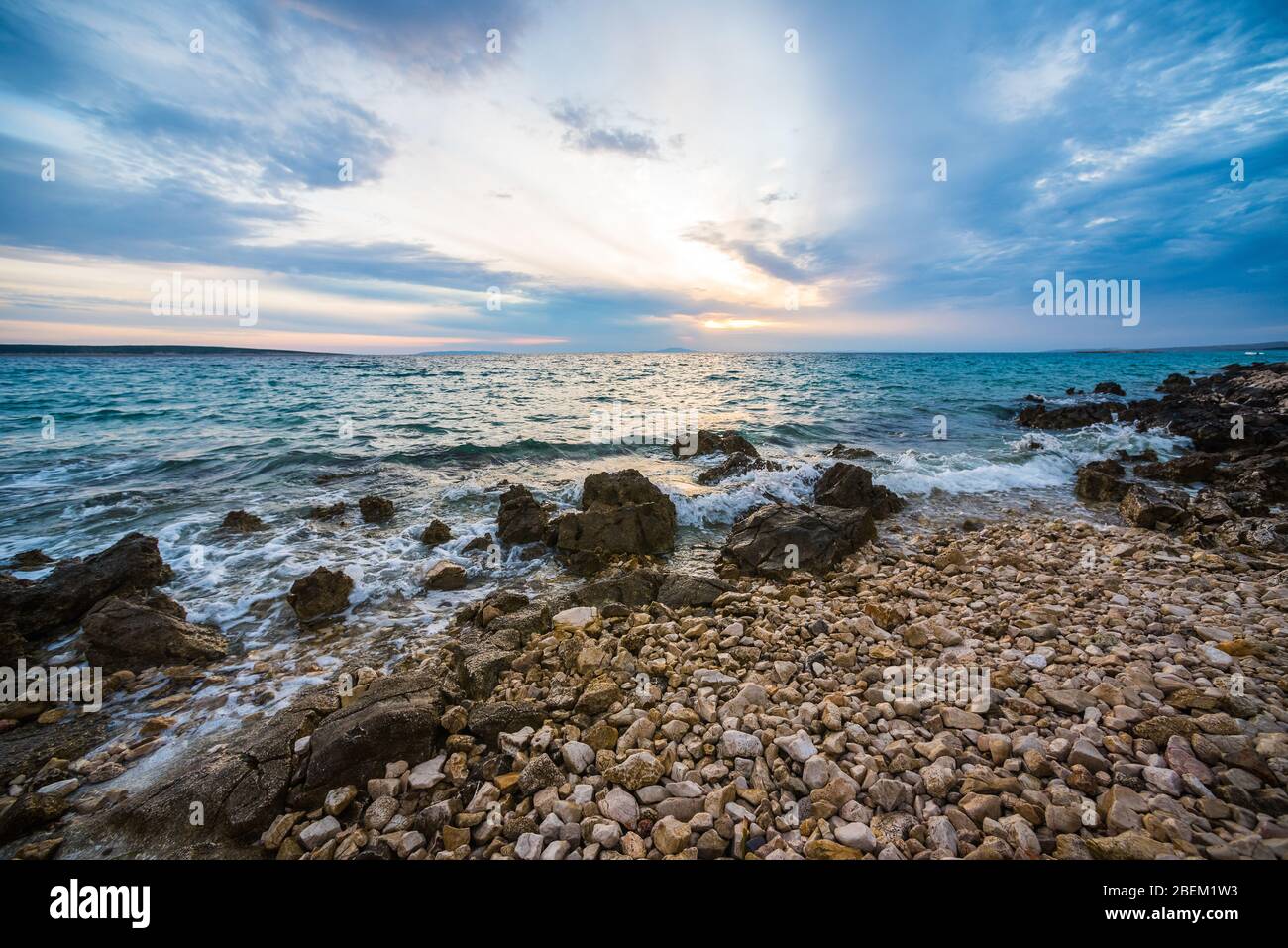sunset on croatian stony beach Stock Photo
