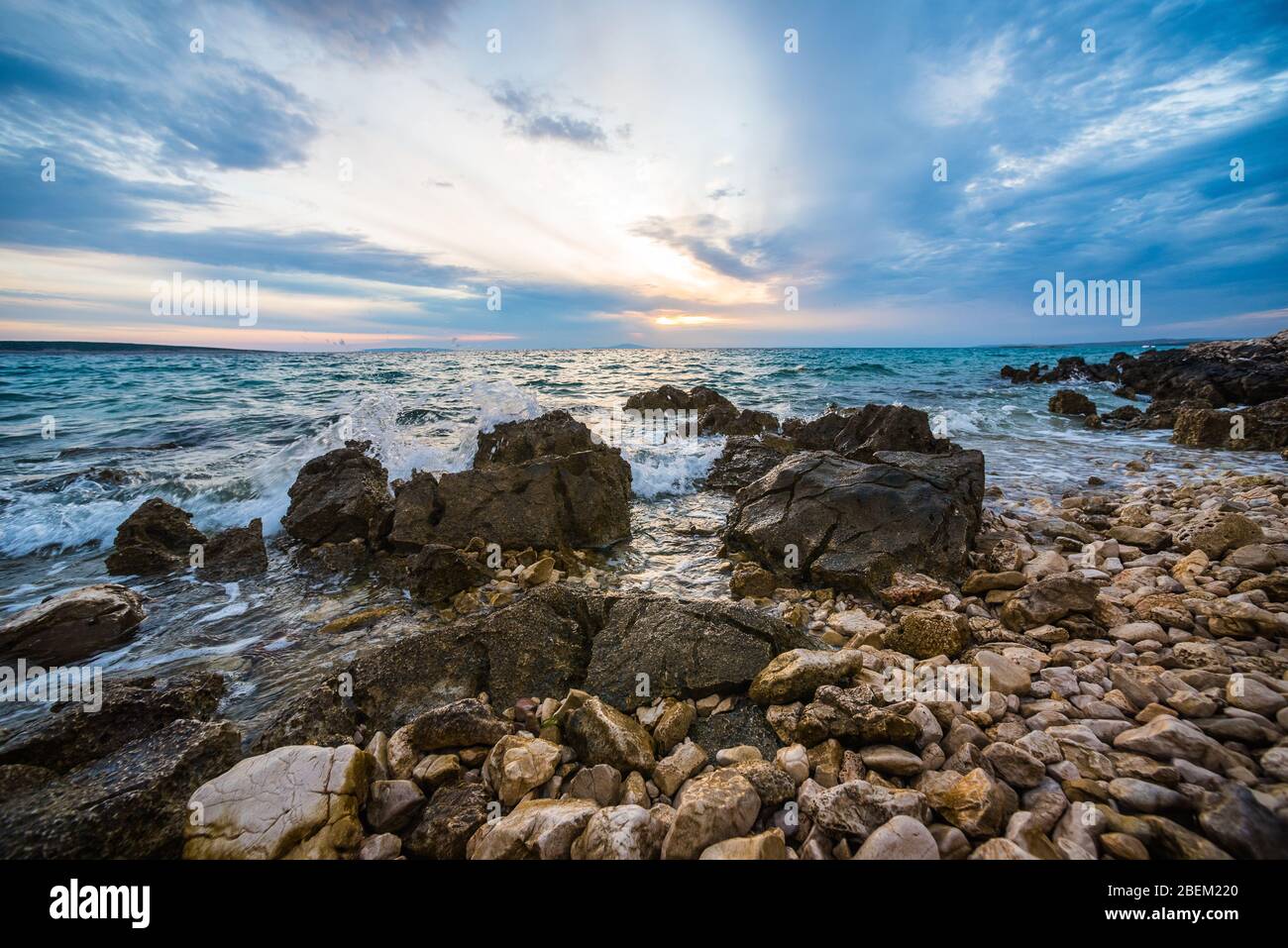 sunset on croatian stony beach Stock Photo