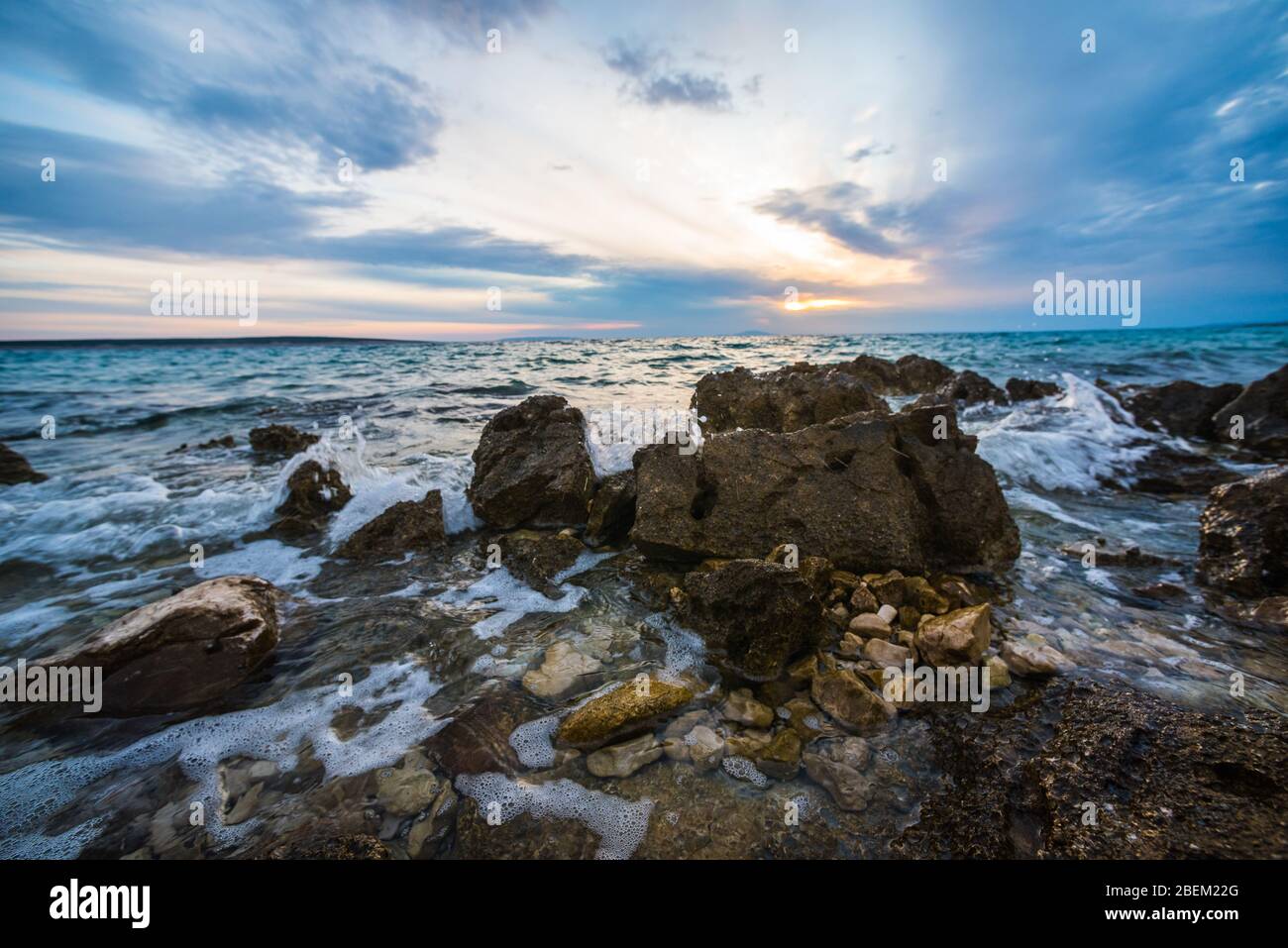 sunset on croatian stony beach Stock Photo
