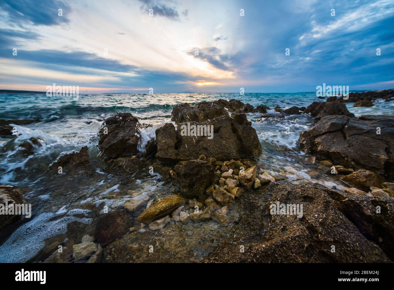 sunset on croatian stony beach Stock Photo