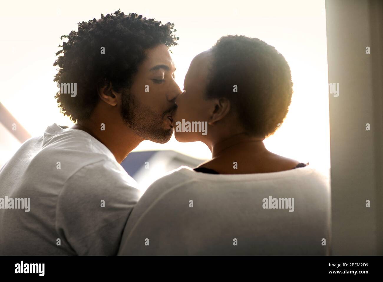 A happy young couple sharing a kiss Stock Photo