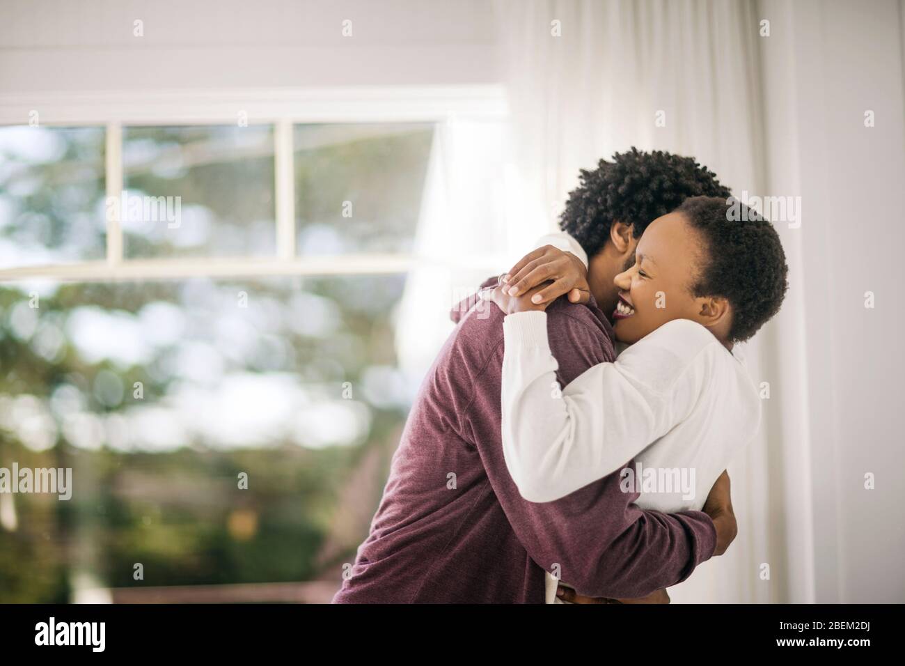 Happy young couple hugging in their new home Stock Photo