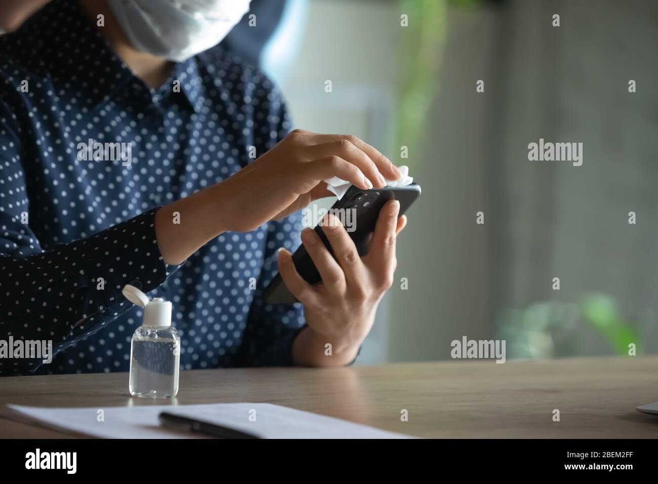 Close up of woman sanitize cell with antibacterial gel Stock Photo