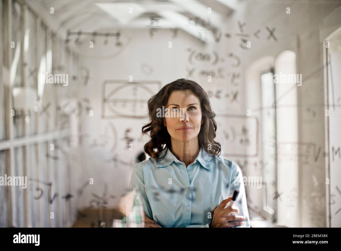 Mathematician working to solve an equation Stock Photo