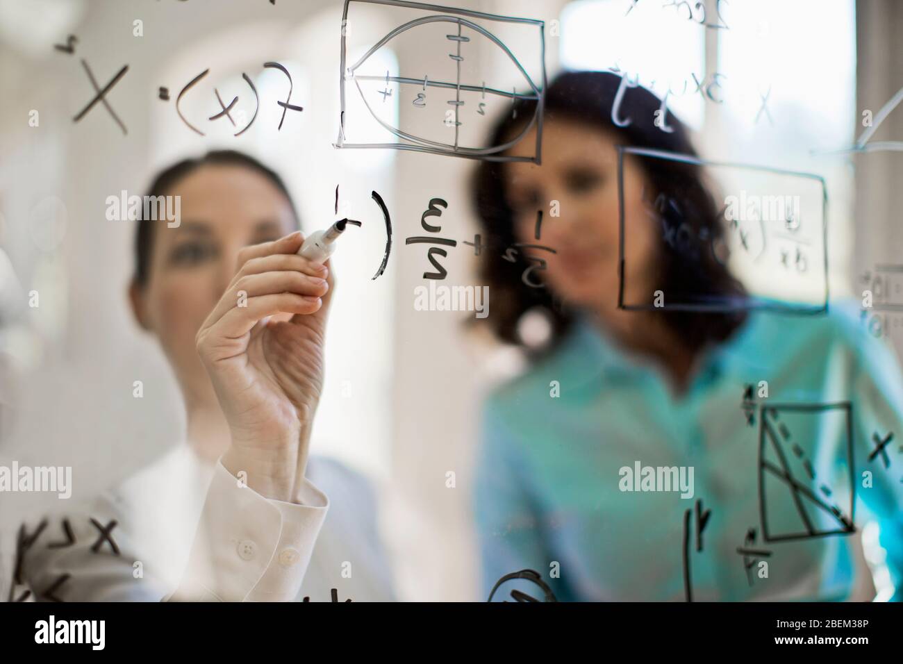 Mathematicians working on solving an equation Stock Photo