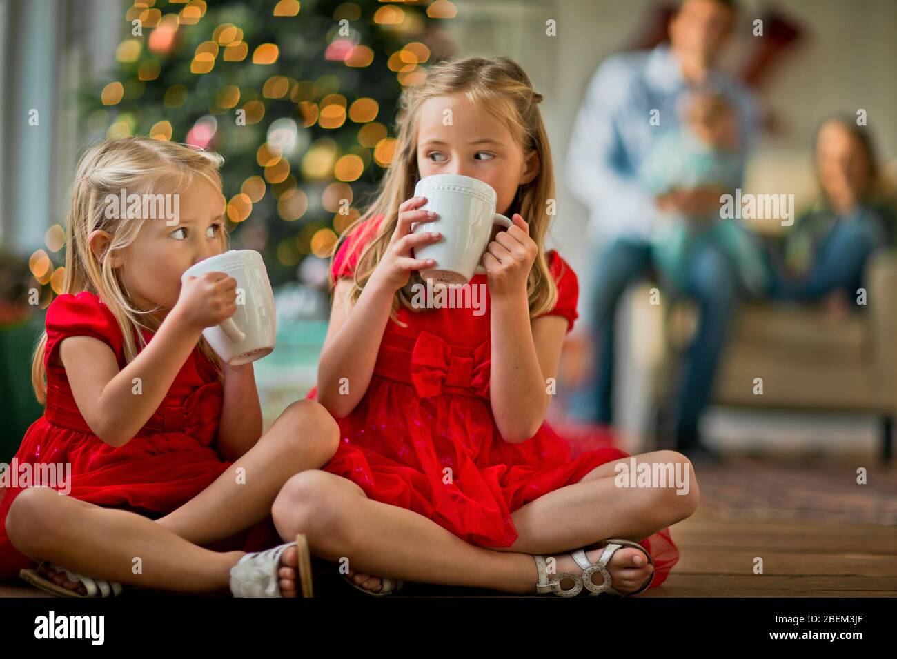 Two young girls drinking hot chocolate Stock Photo