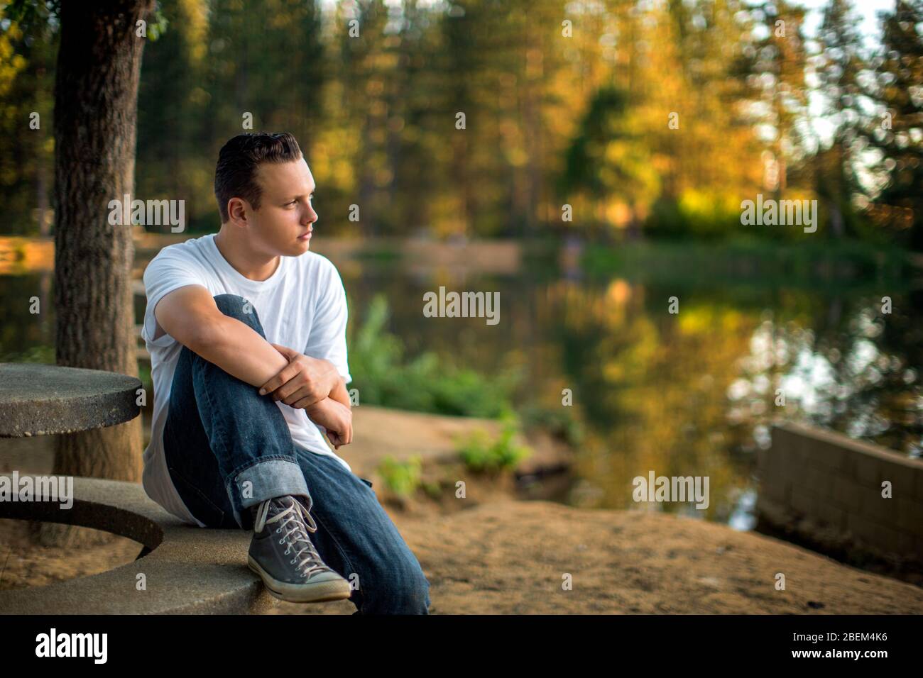Young man sitting picnic table hi-res stock photography and images - Alamy