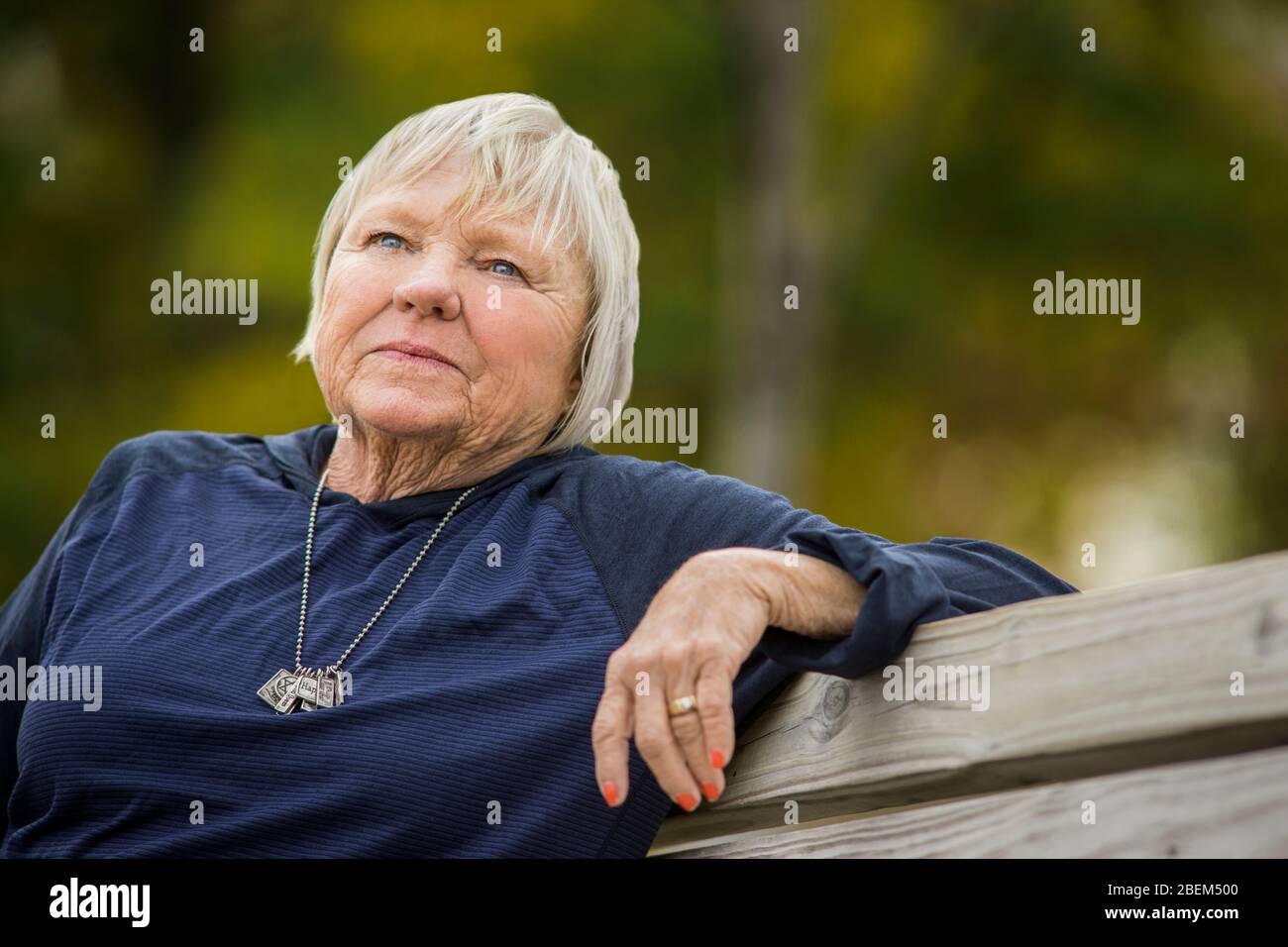 Portrait of a senior woman sitting on a bench Stock Photo