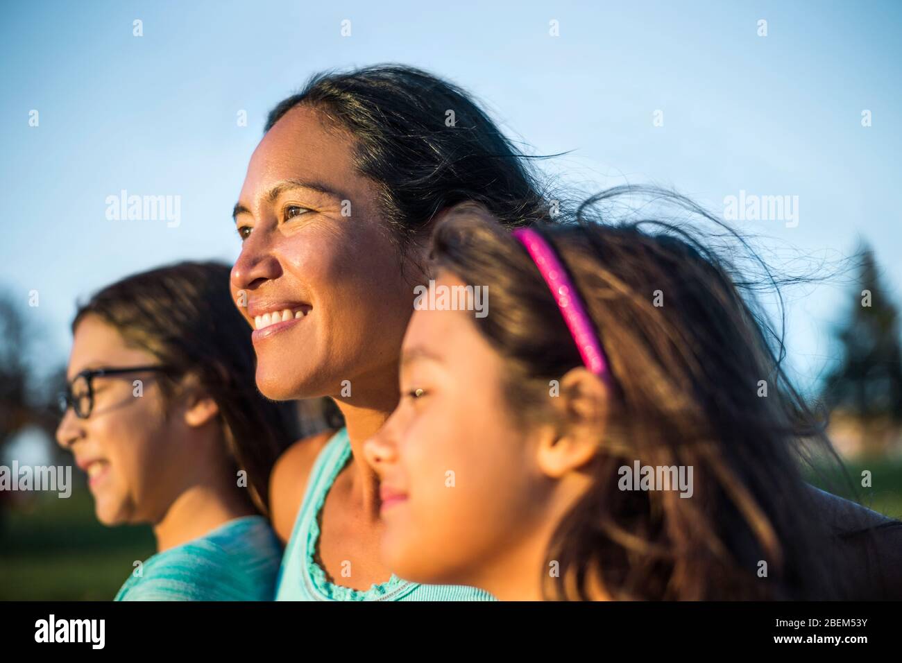 Portrait of smiling mid adult mother and daughters Stock Photo