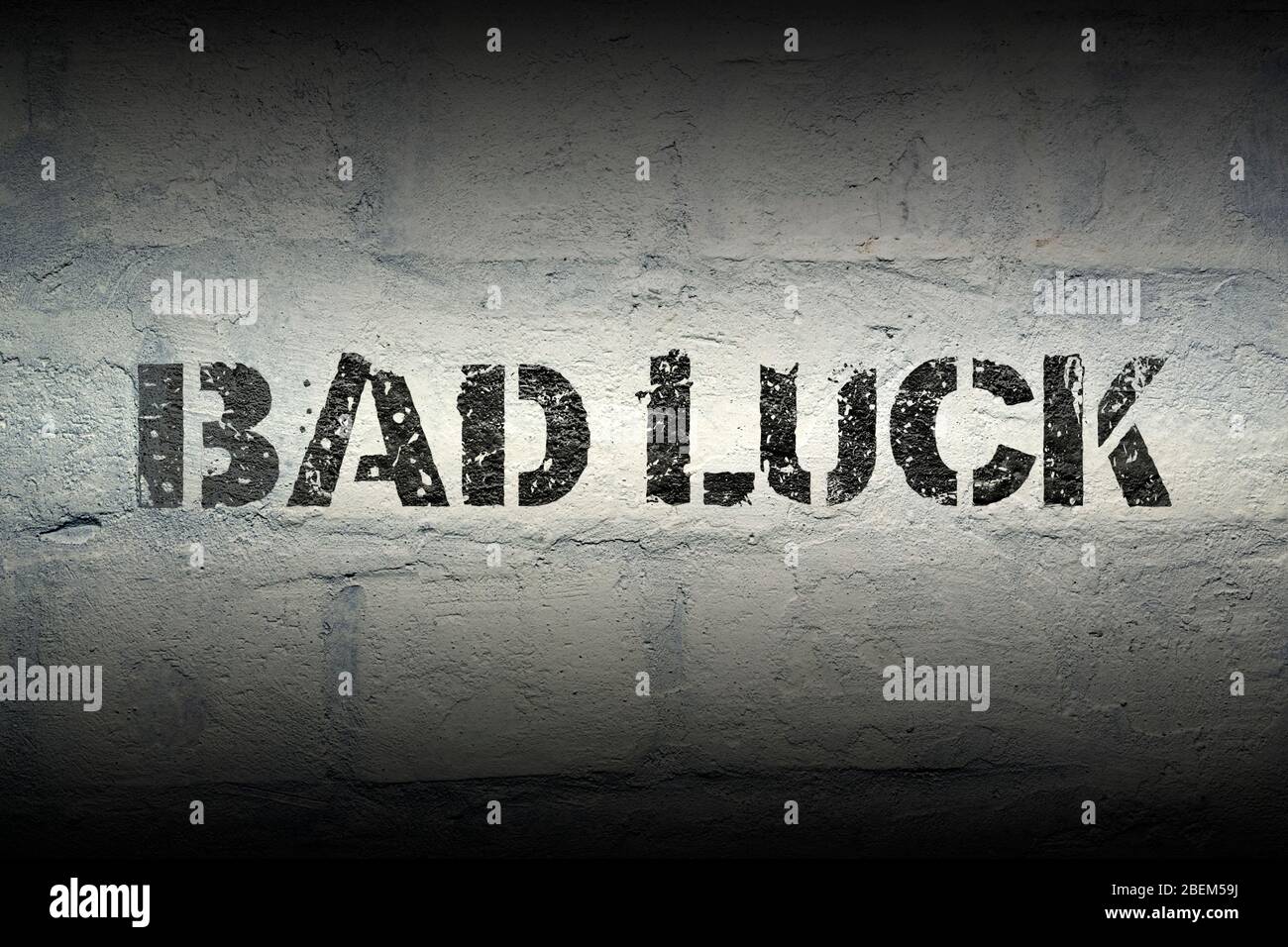 bad luck stencil print on the grunge brick wall with gradient effect Stock Photo