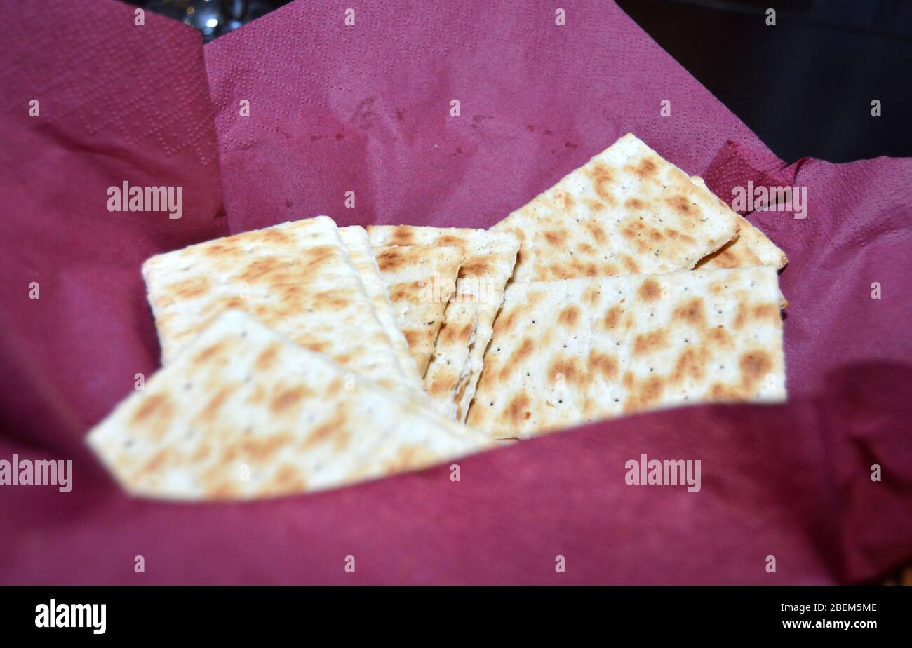 Closeup of several saltine crackers in a basket lined with a dark red napkin, fresh saltines for a quick snack Stock Photo