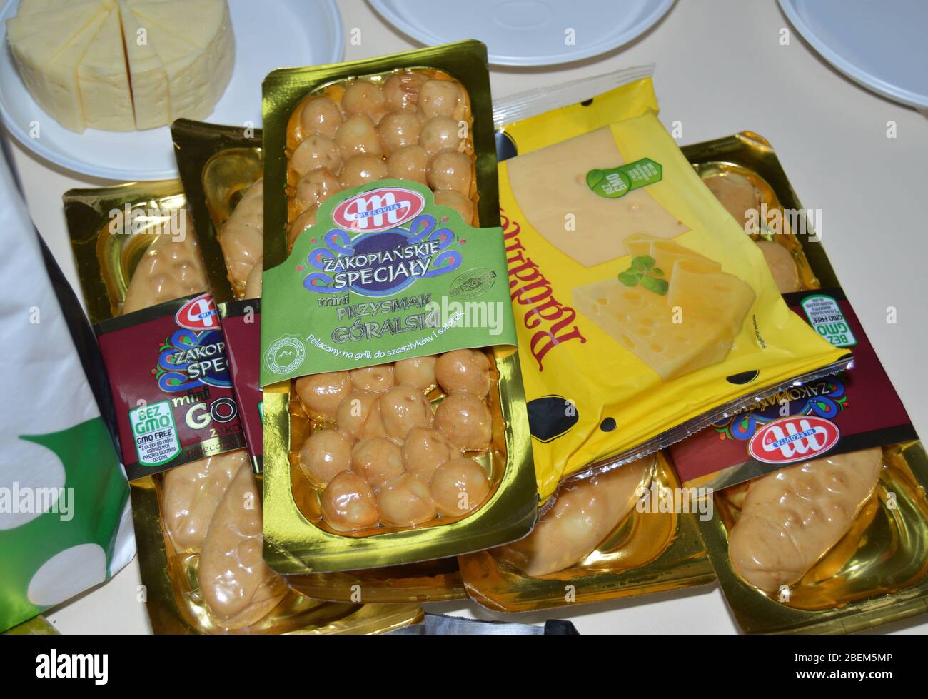 Polish cheese brands: Tilsit or Tylżycki, Gołka or Gouka and Oscypek cheeses packaged, smokey cheese straight from Poland before being open and sliced Stock Photo