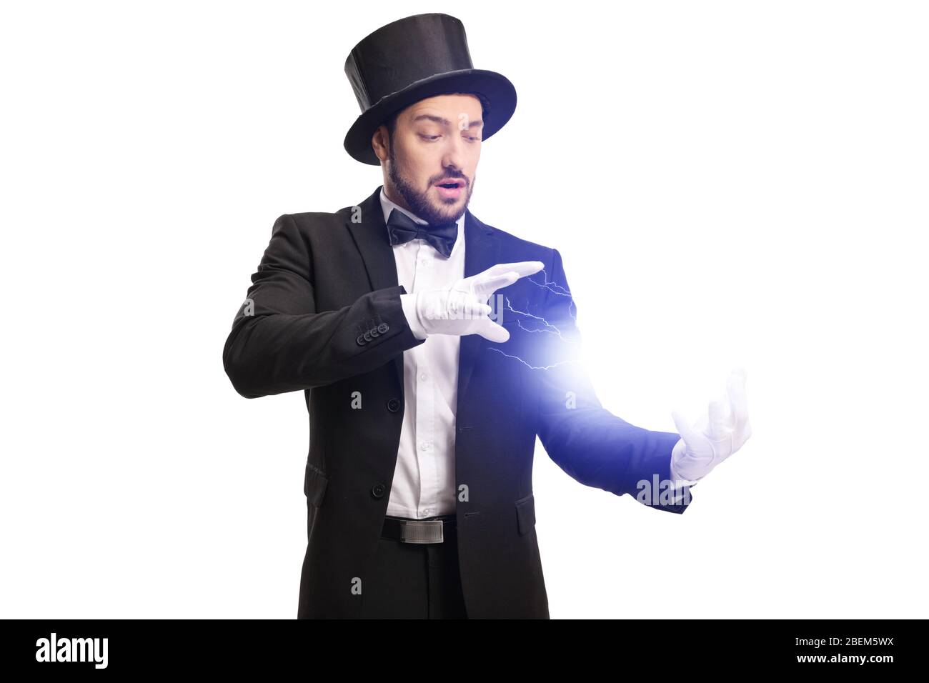 Magician performing a trick with electricity with his hands isolated on ...
