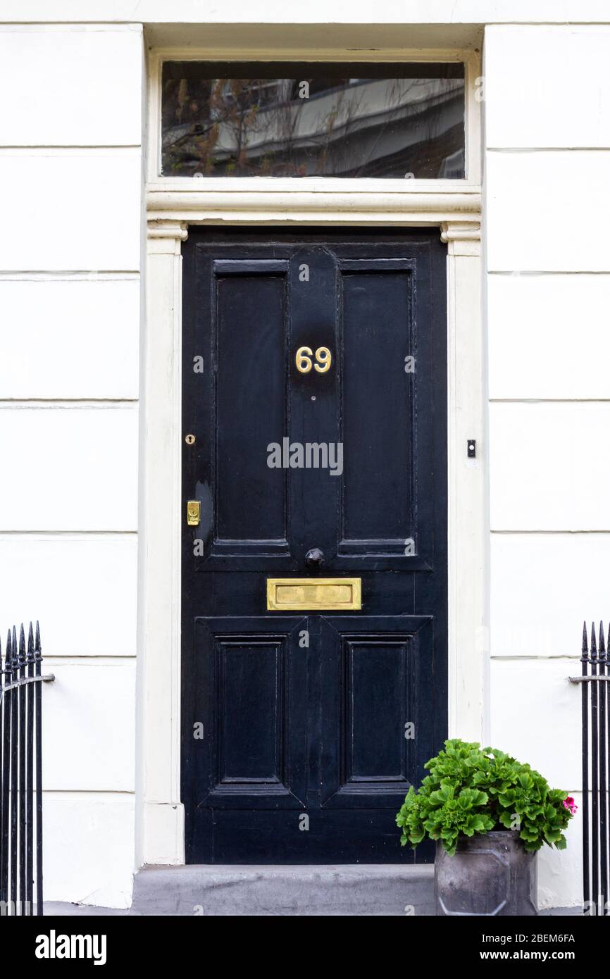 Elegant house front door with the number 69 Stock Photo