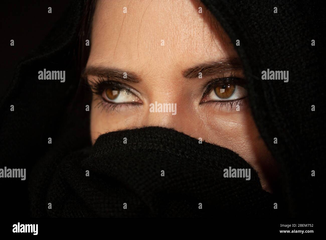 Portrait of a young mexican woman with her beautiful honey eyes wearing traditional islamic cloth Stock Photo