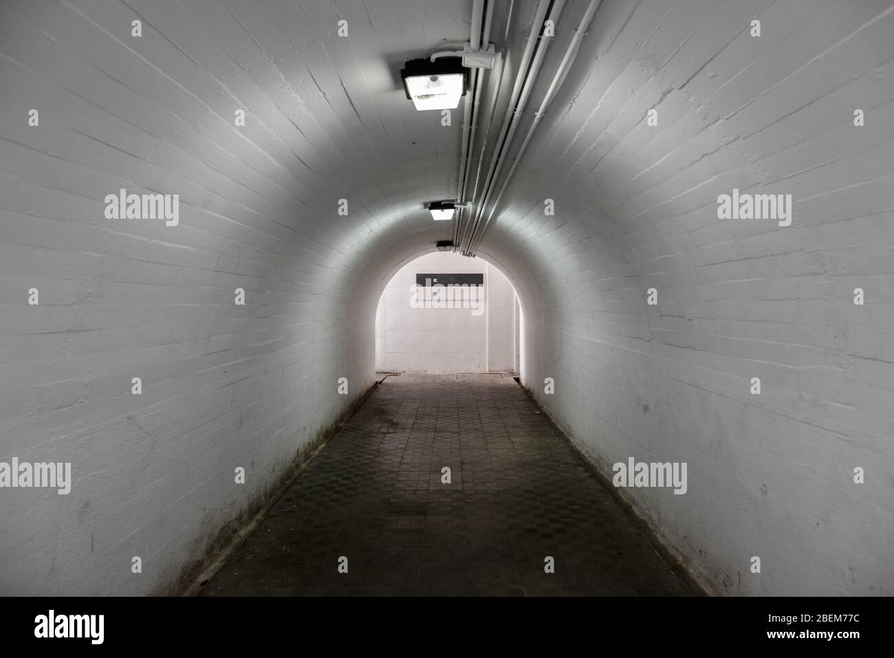 Empty Underground Corridor with Light on The End of Tunnel Stock Photo