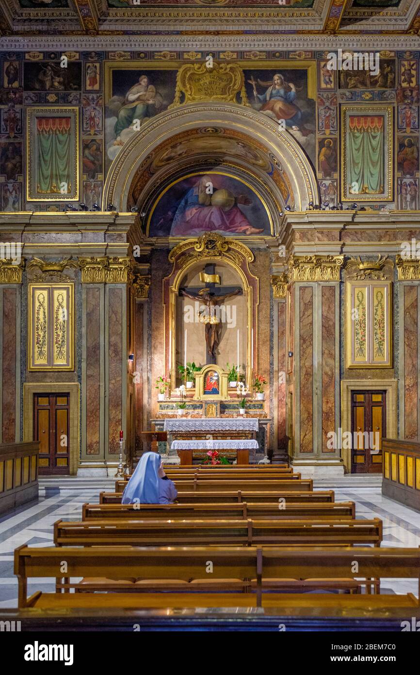 Catholic, alone Christian nun, interior of Oratorio del Santissimo Crocifisso (Oratory of the Most Holy Crucifix), Mannerist paintings, Rome, Italy Stock Photo