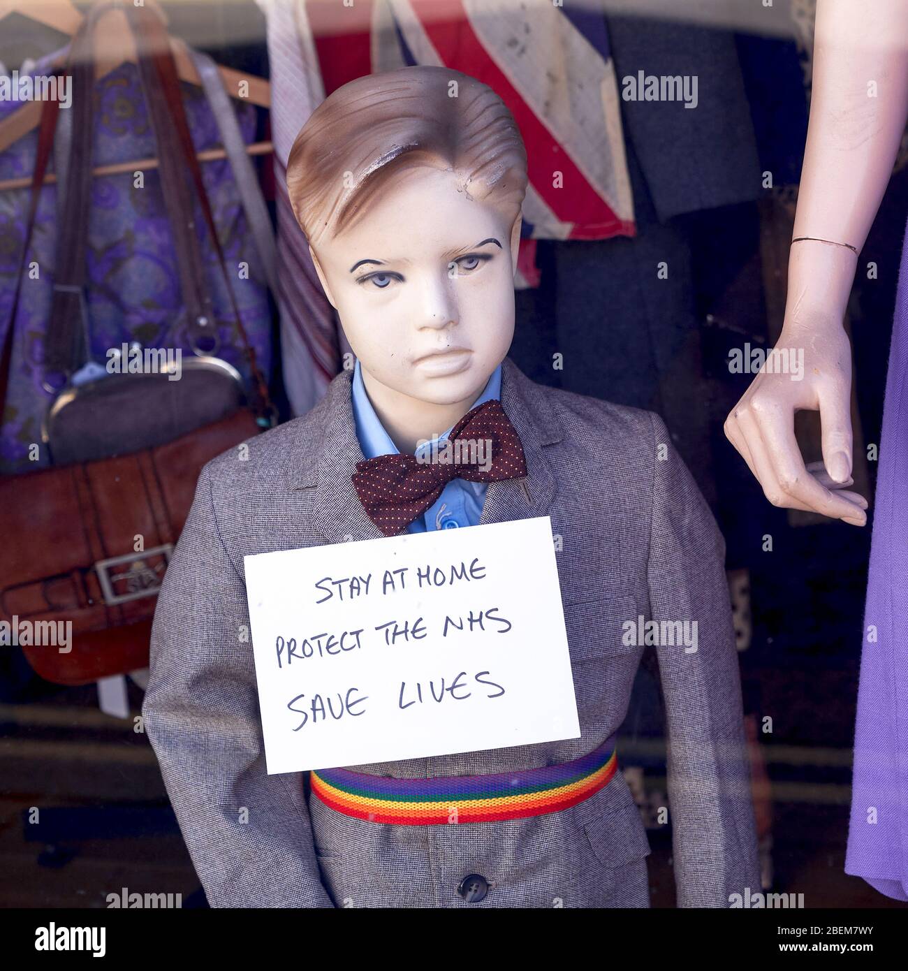 Mannequin dummy of a small boy with a sign giving advice during Covid-19 Coronavirus emergency Stock Photo