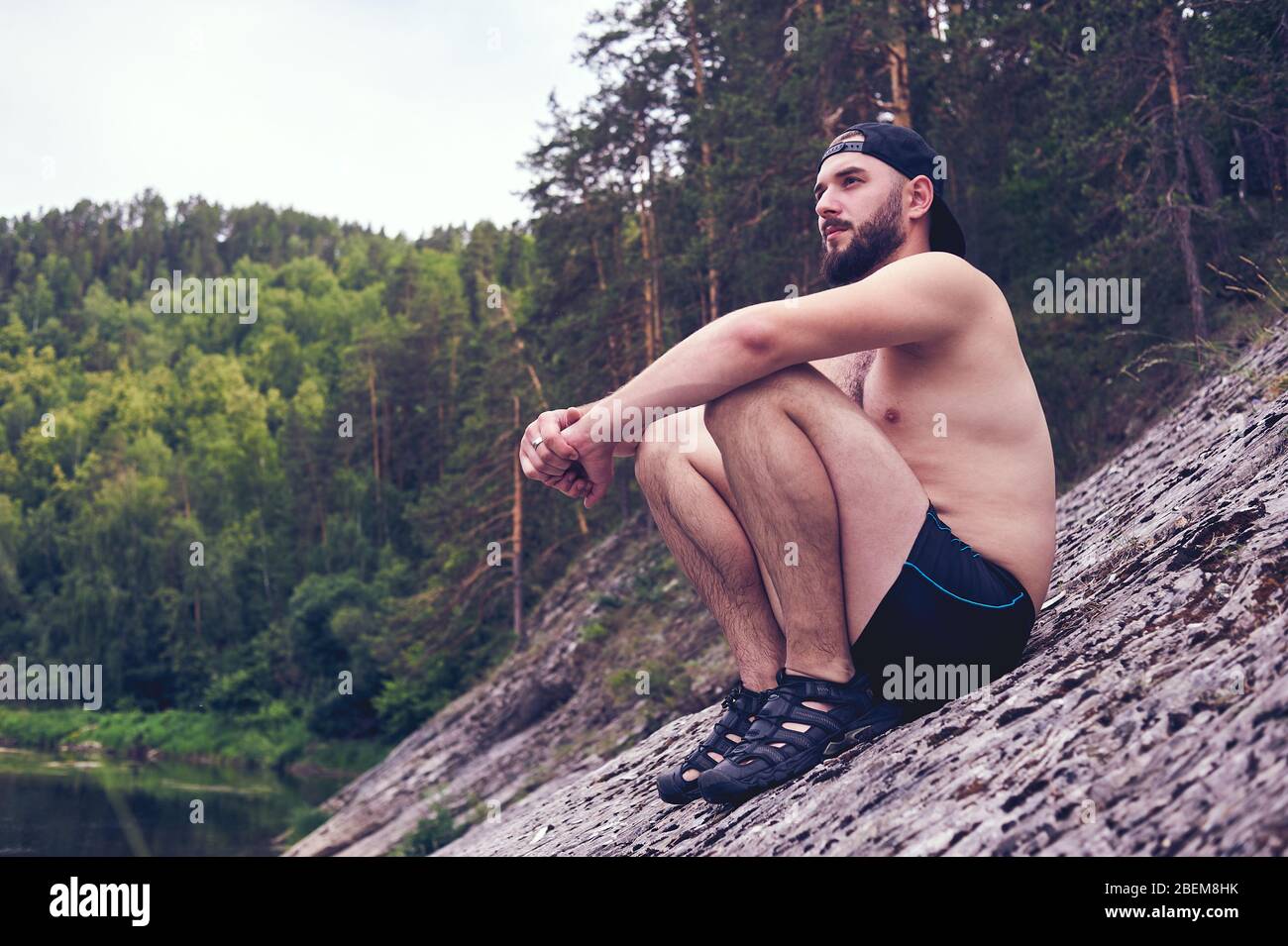 Enjoying life. A young man lies in a bivouac in the forest., relaxation, vacations, lifestyle concept Stock Photo