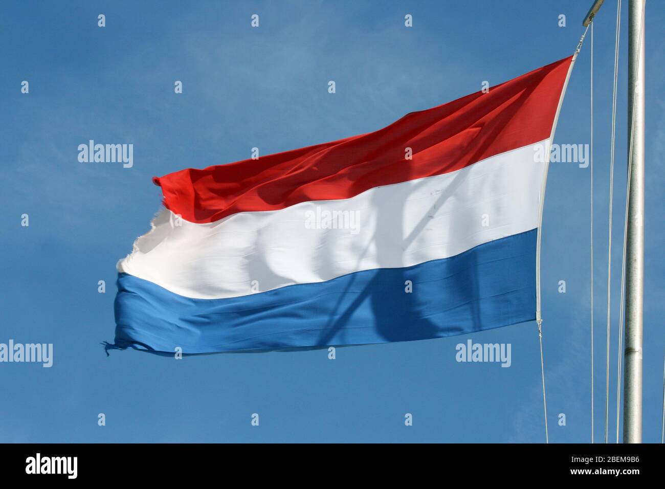 Flag of the Netherlands with blue sky in the backgroundFlagge der Niederlande mit blauem Himmel im Hintergrund Stock Photo