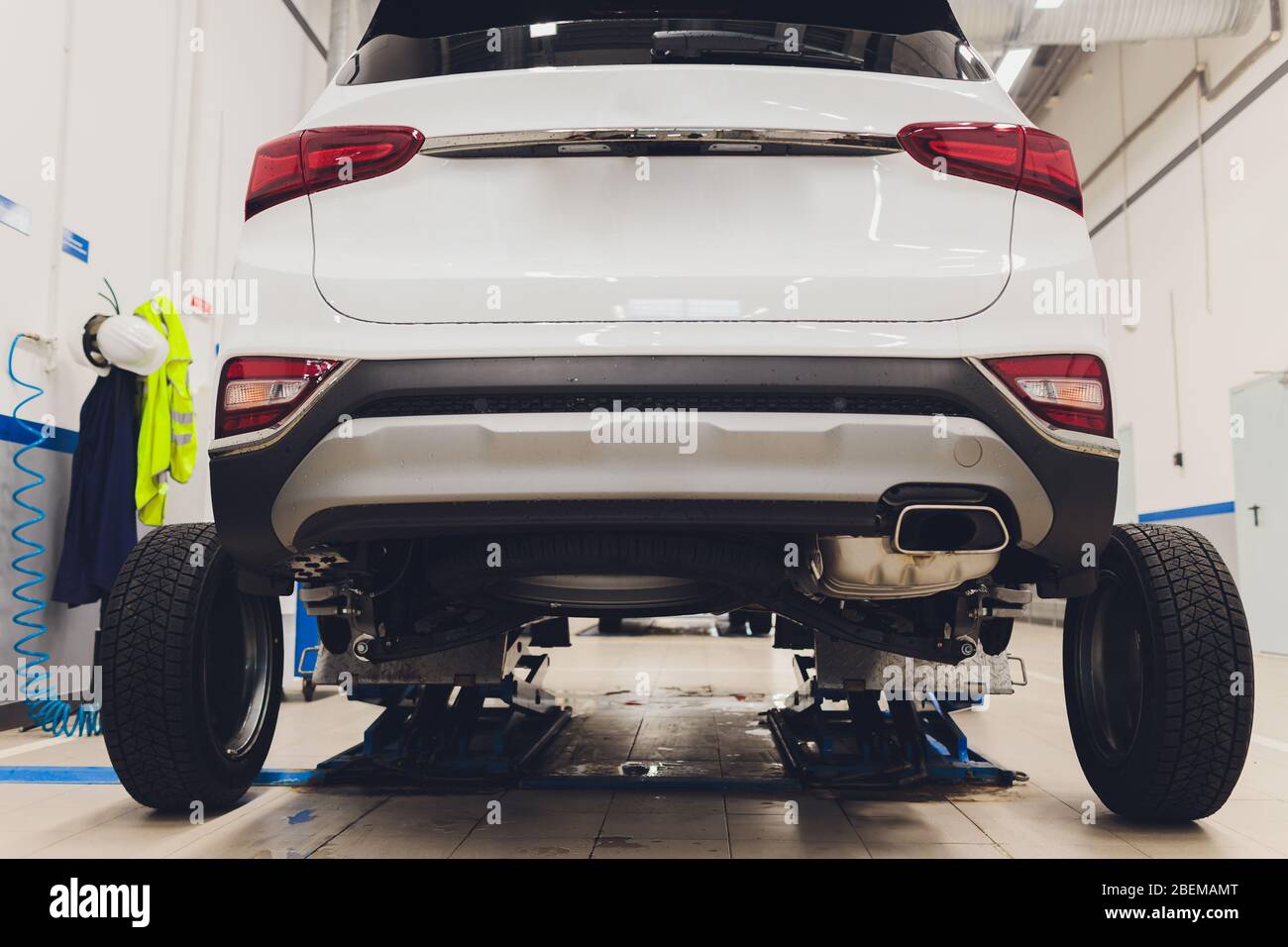 modern car service. back view of car in room service. Wheel replacement ...