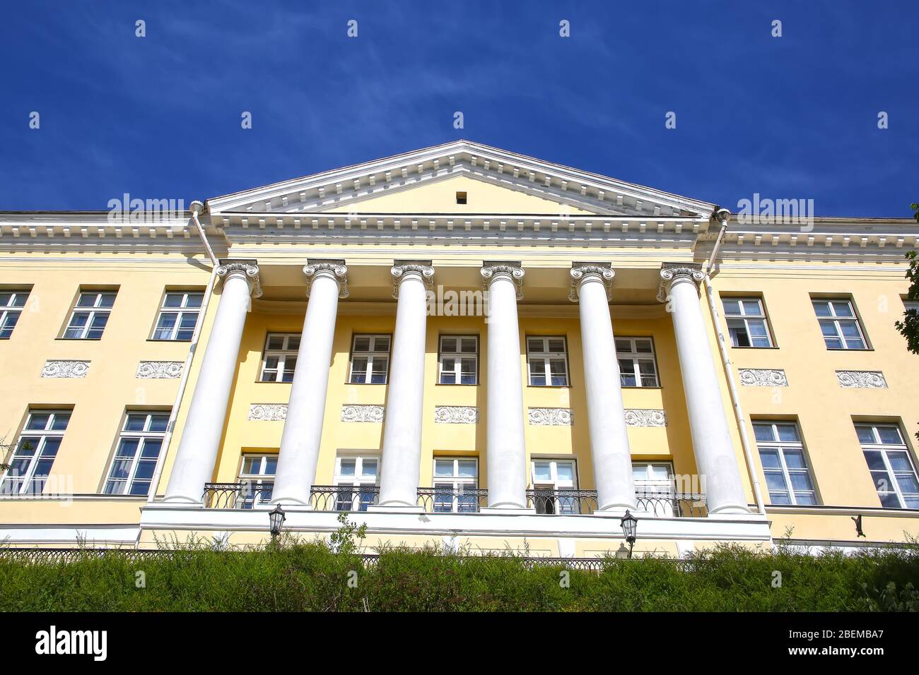 Historic building in the old town of Tallinn, Estonia. Painted yellow with columns on a beautiful day. Stock Photo