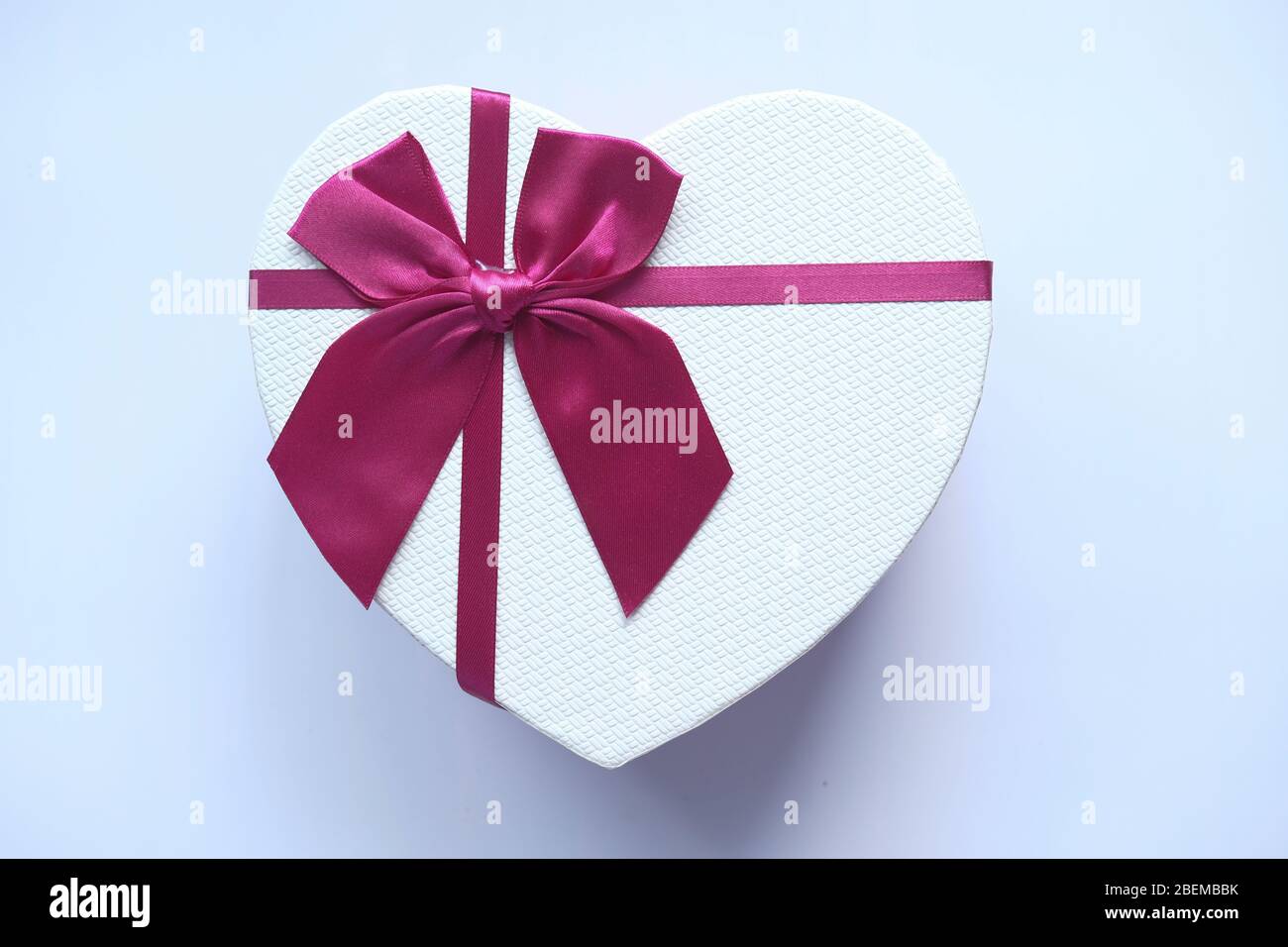 Red heart shape gift box isolated on white. Stock Photo