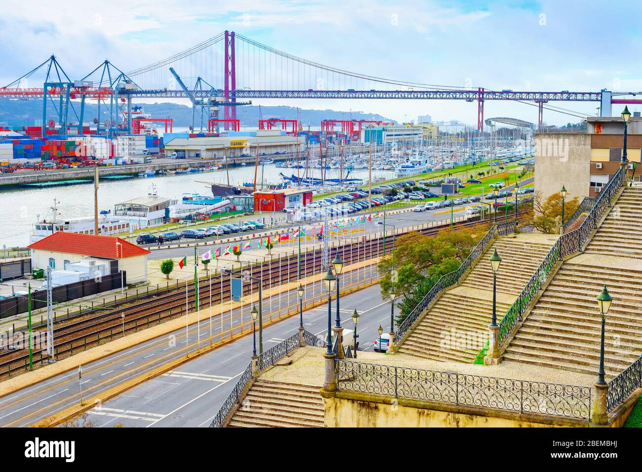 Paved stairs to commercial port of Lisbon at Tagus river, ships, cranes ...