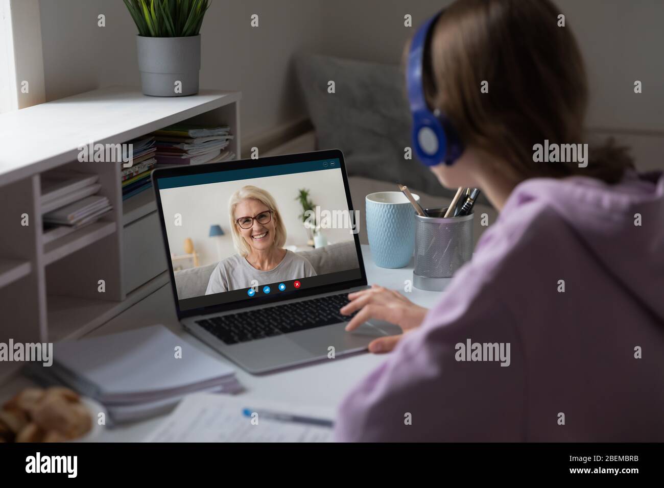 Distant lesson with middle-aged teacher using video conference application Stock Photo