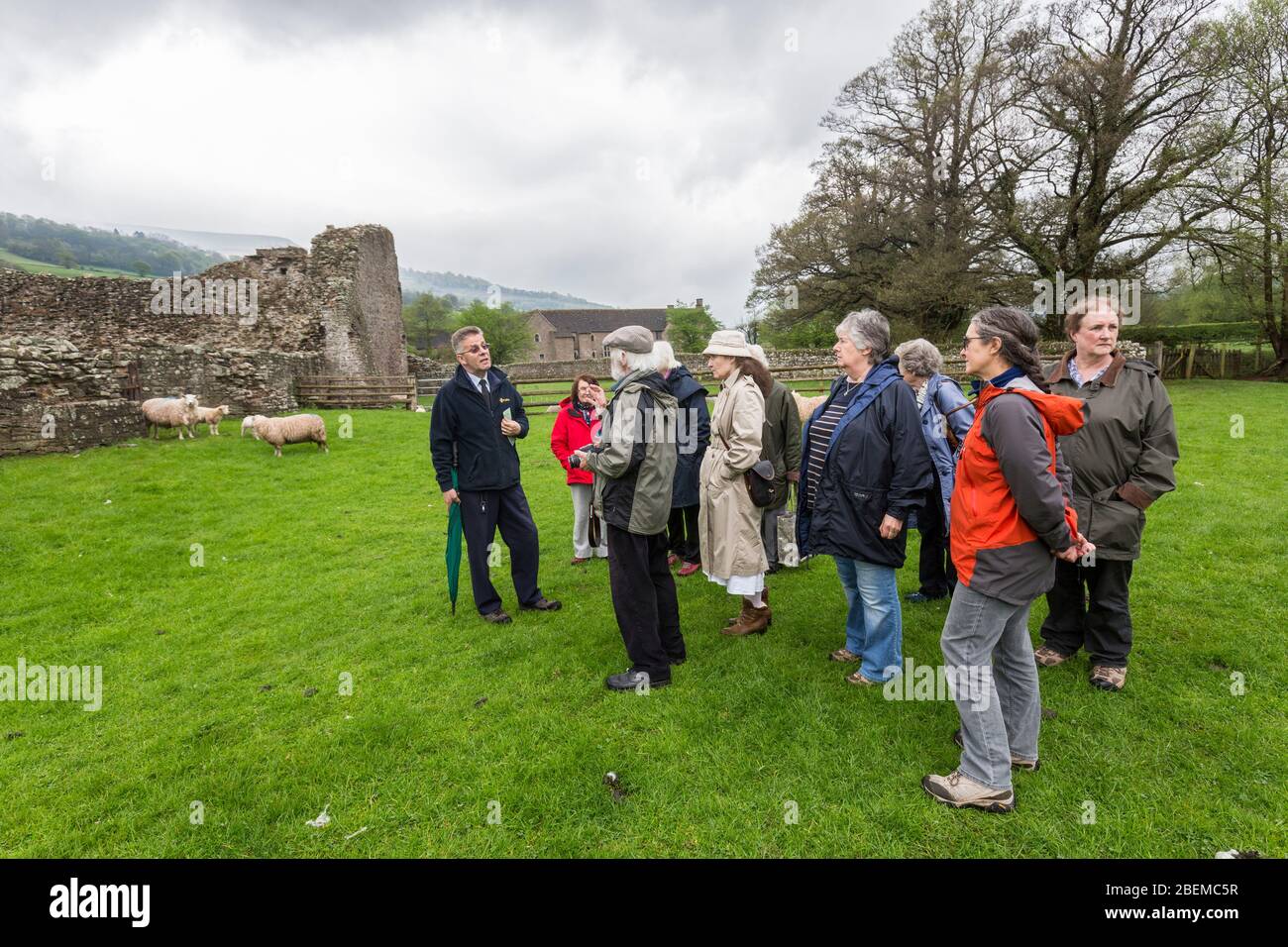 Welsh Tour Guide Tour group with guide at Tretower Court and Castle, Wales, UK Stock ...