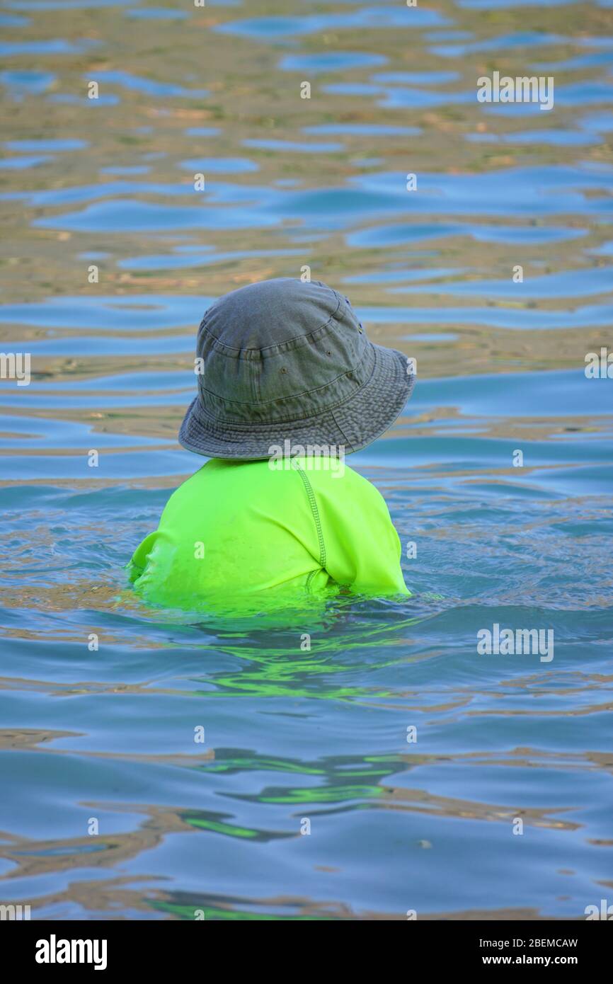 Small child playing in the water Stock Photo
