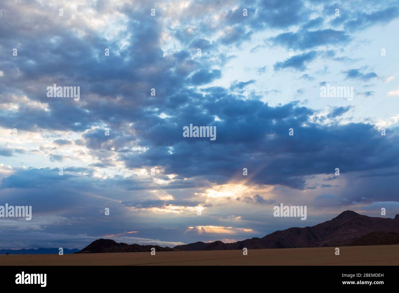 Sun shining through gaps in the clouds Stock Photo - Alamy