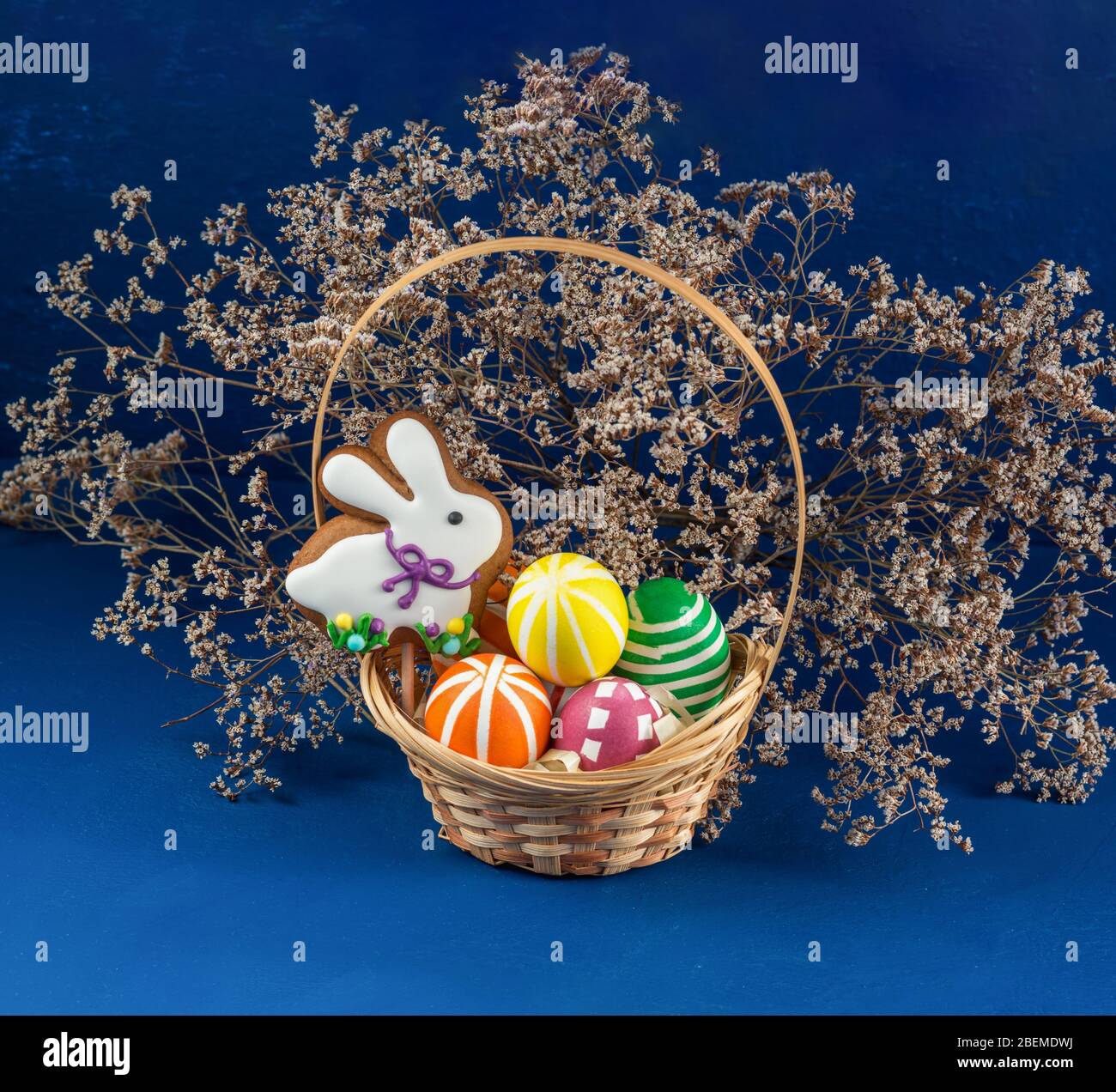 Easter Bunny and colorful eggs on a blue background. Spring chrestian ...