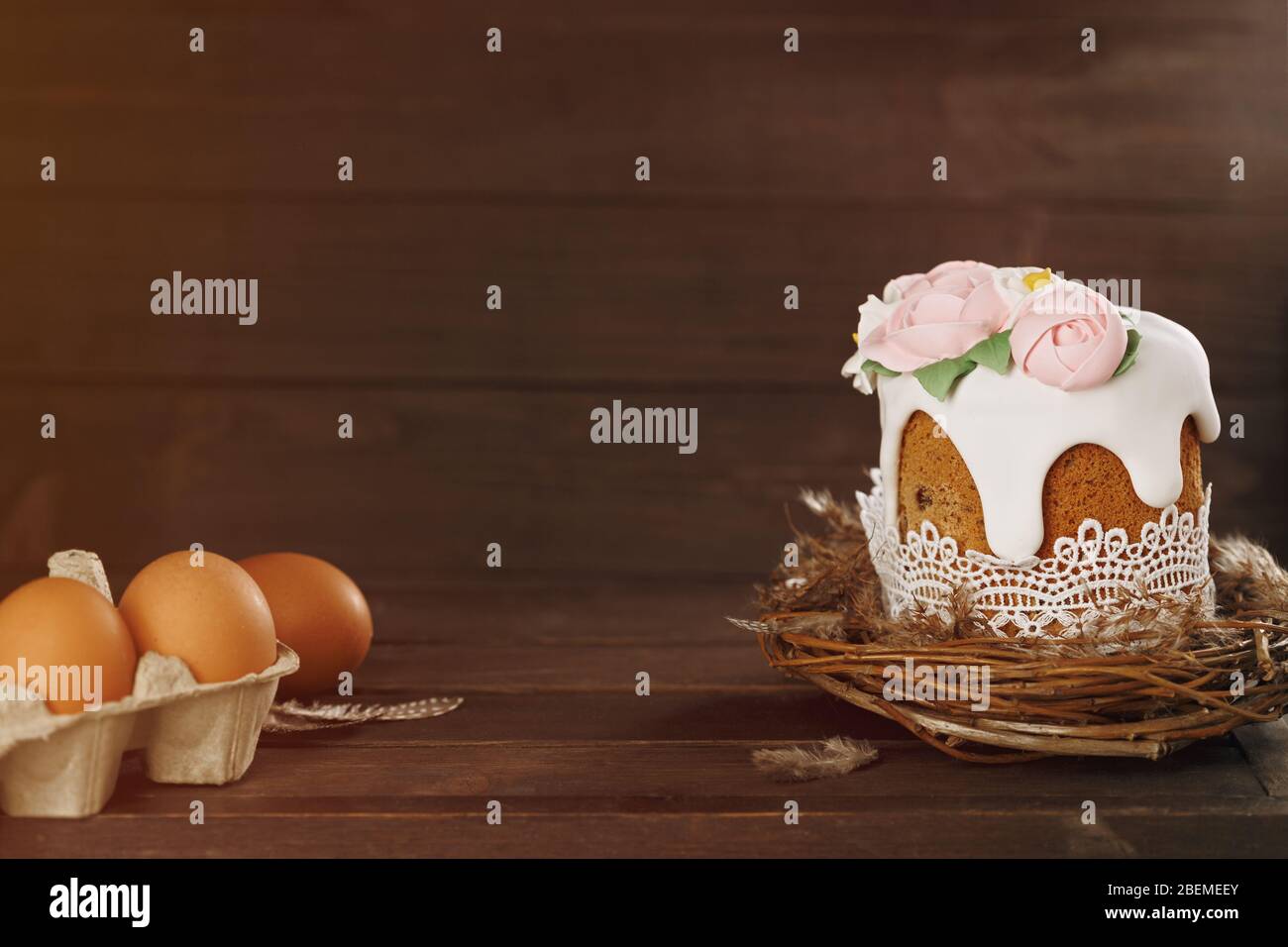 Easter rustic background. Handmade cake in nest with eggs on wooden background. Holiday concept. Happy Easter, copy space Stock Photo
