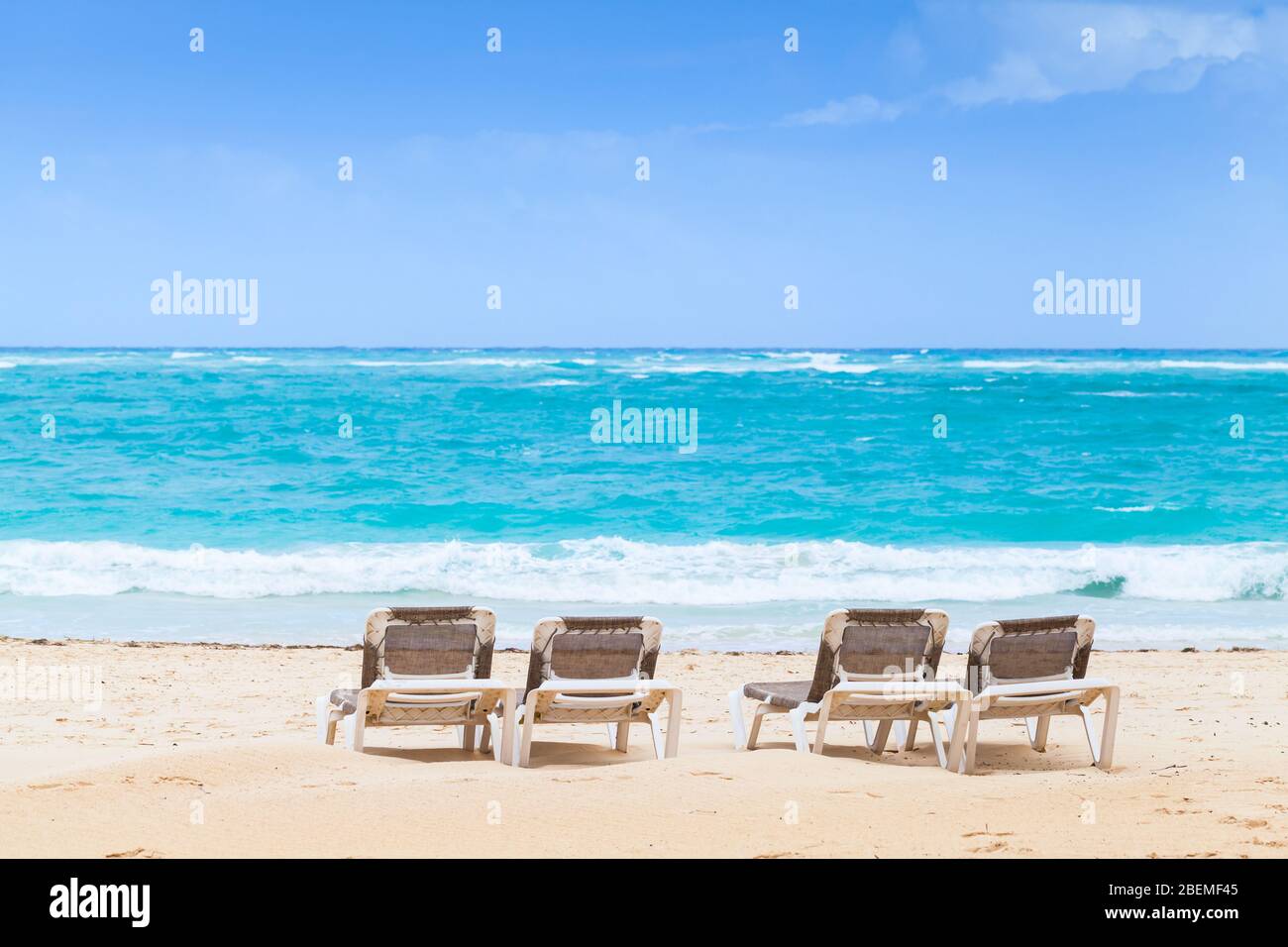 Sunloungers are on sandy beach at sunny day, Dominican Republic Stock Photo