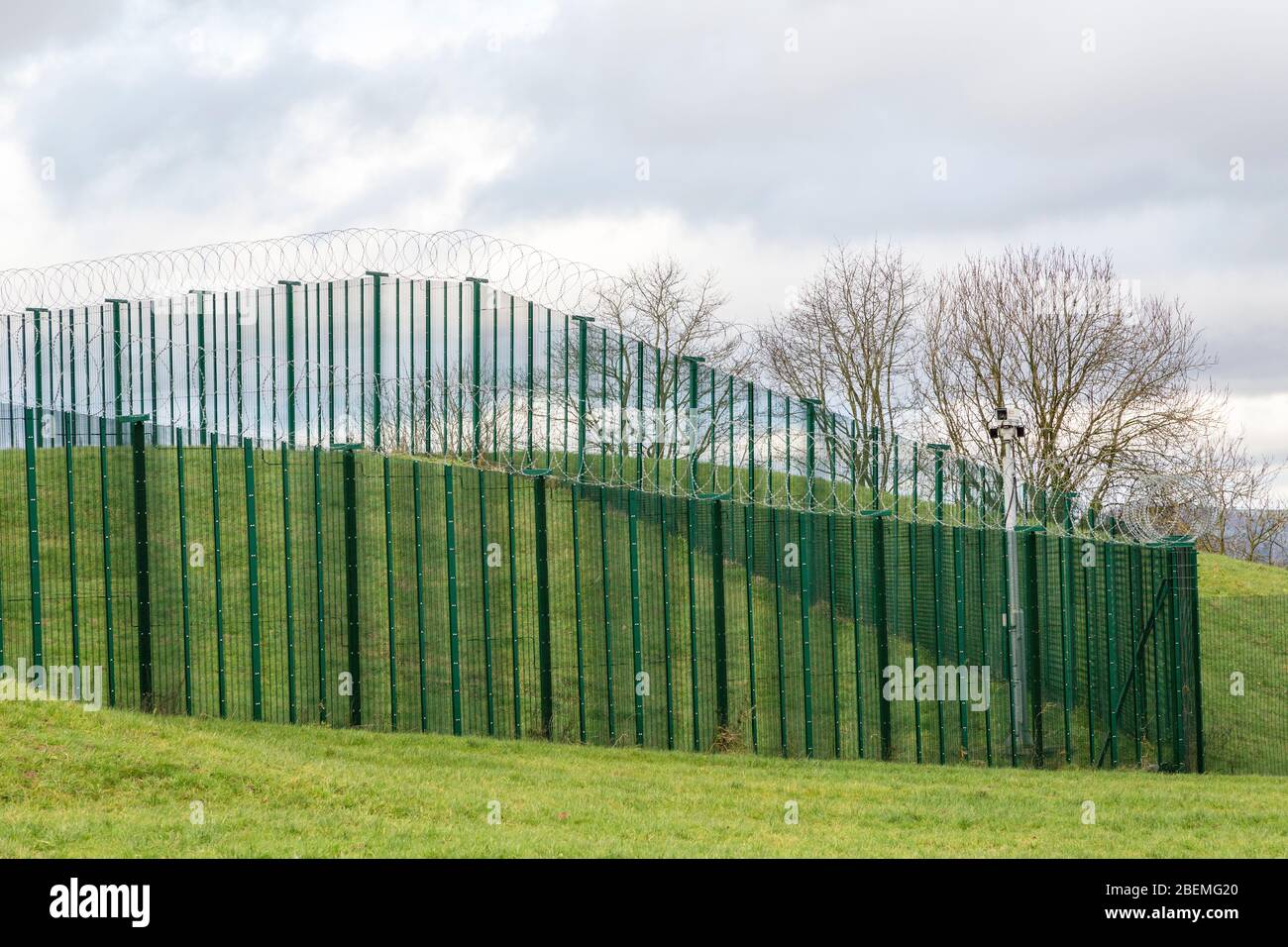 Security fence, camera and razor wire, Llandegfedd reservoir, Wales, UK Stock Photo