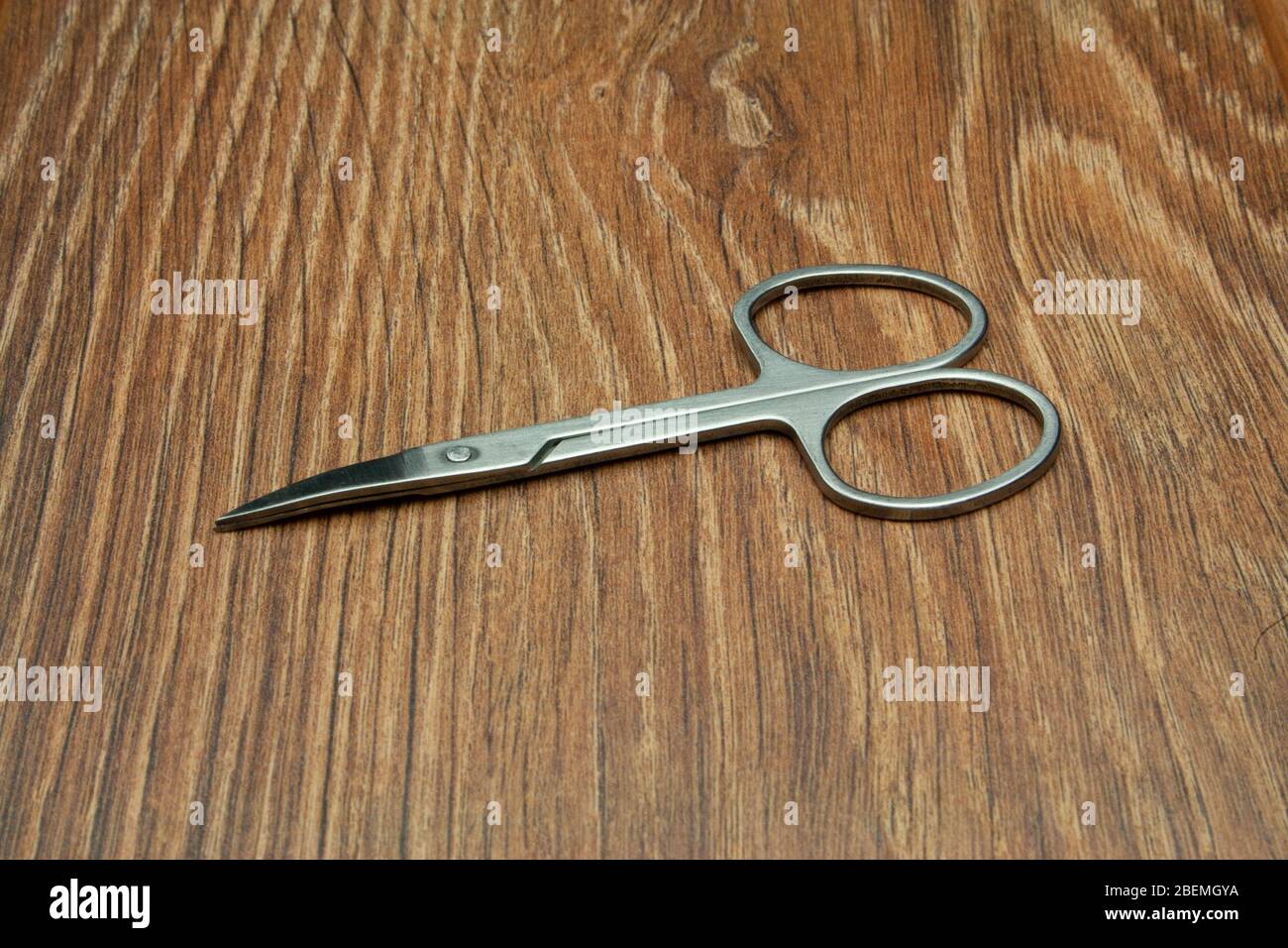 Close-up manicure scissors isolated on wooden background Stock Photo