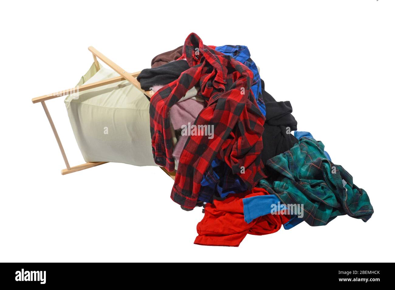 Horizontal shot of an overloaded laundry basket that fell over.  White background. Stock Photo