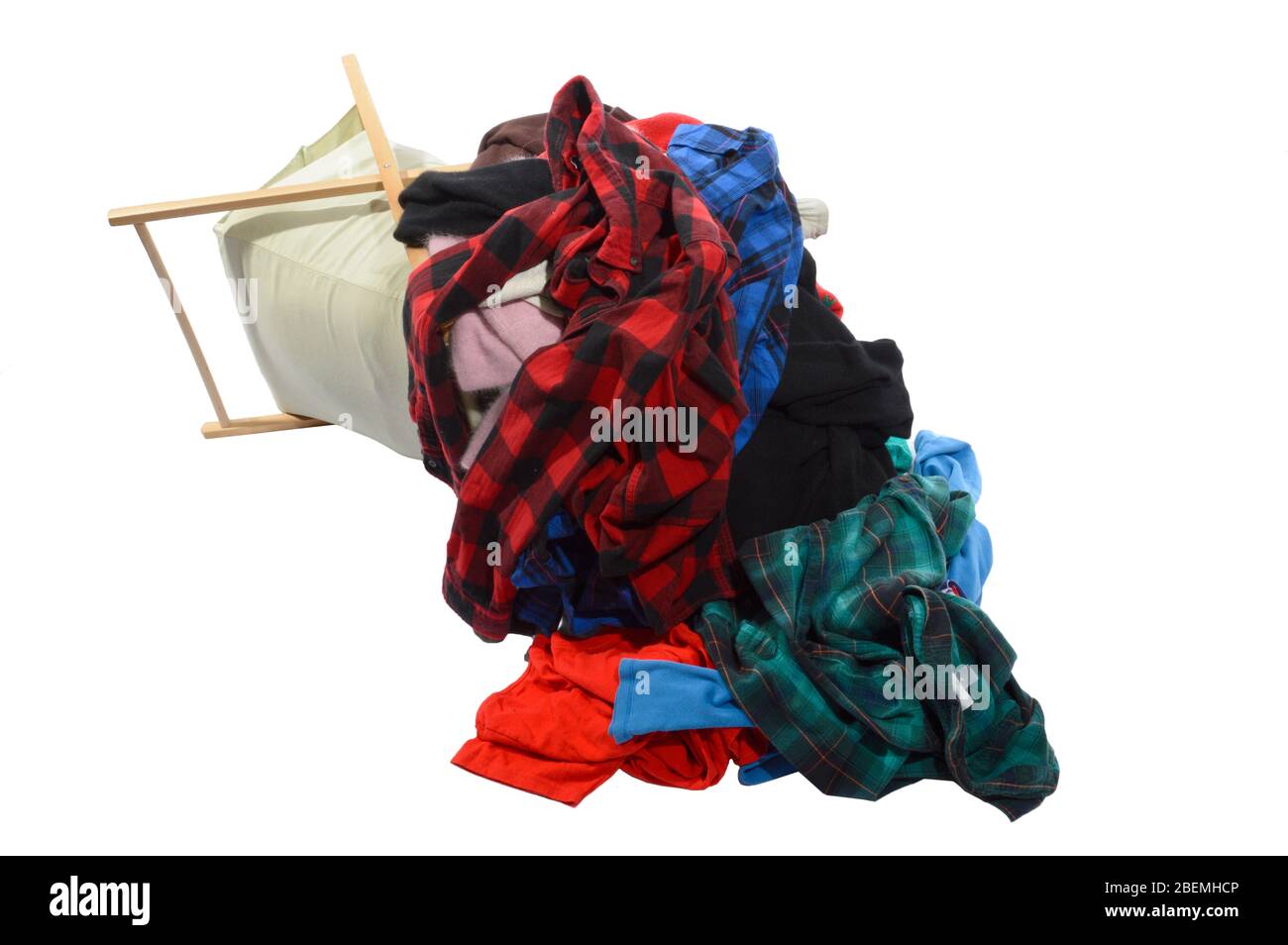 Horizontal shot of an overstuffed laundry basket that fell over.  Shot on an angle.  White background. Stock Photo