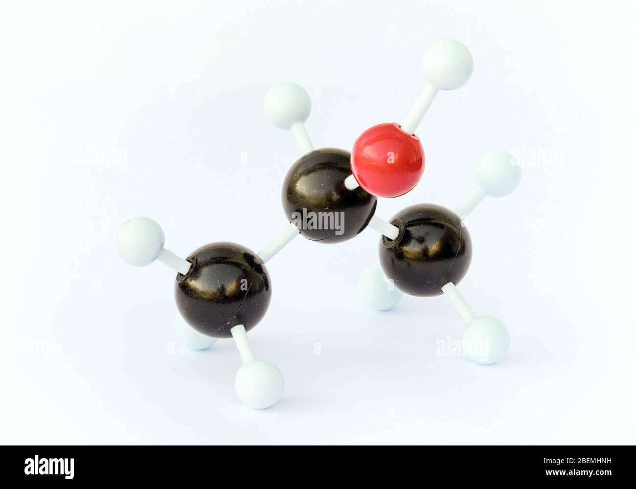 Plastic ball-and-stick model of an isopropyl alcohol (isopropanol) molecule against a white background. Stock Photo