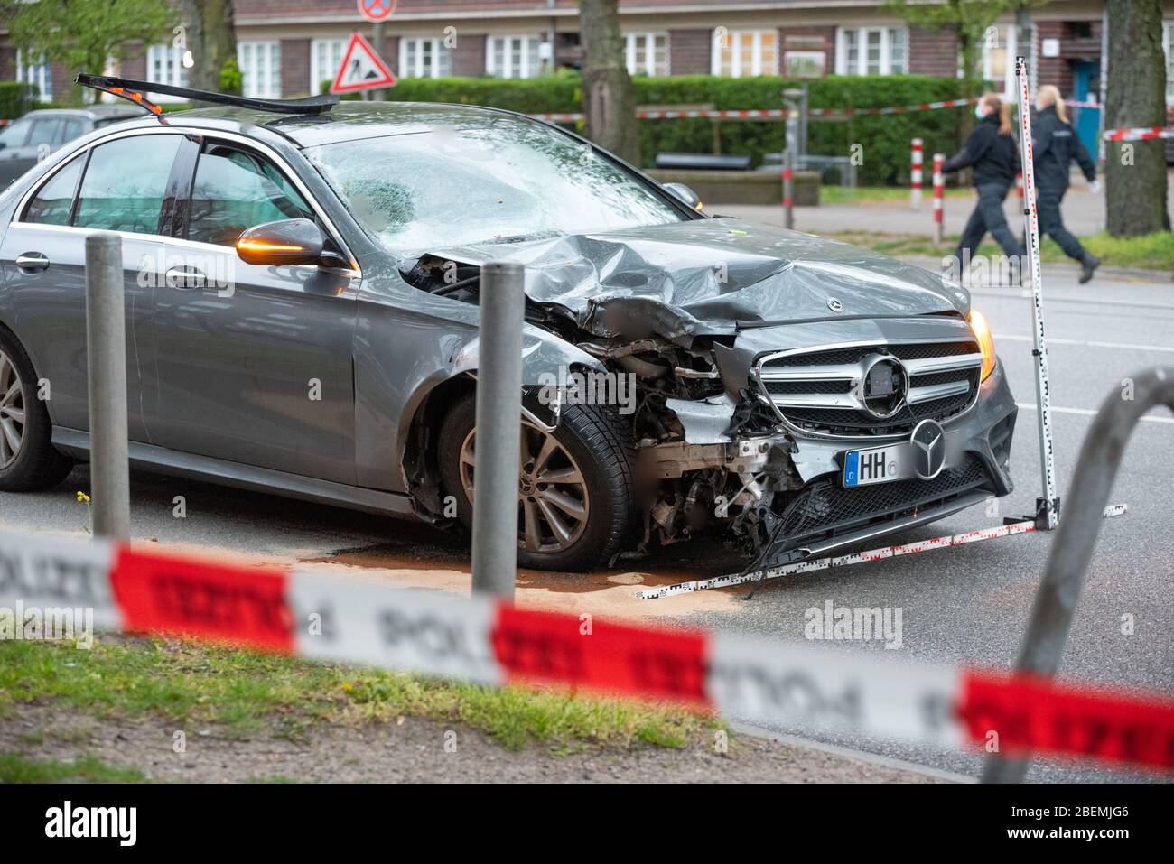 Hamburg, Germany. 14th Apr, 2020. The badly damaged Mercedes stands on the road after the accident. The vehicle had gone off the road in the Altona district, skidded into a traffic light and hit two people. The man and the woman suffered life-threatening injuries. The driver was 'apparently' intoxicated, according to a spokeswoman for the Hamburg Police Situation Center. Credit: Jonas Walzberg/dpa - ATTENTION: The license plate was pixelated for legal reasons/dpa/Alamy Live News Stock Photo