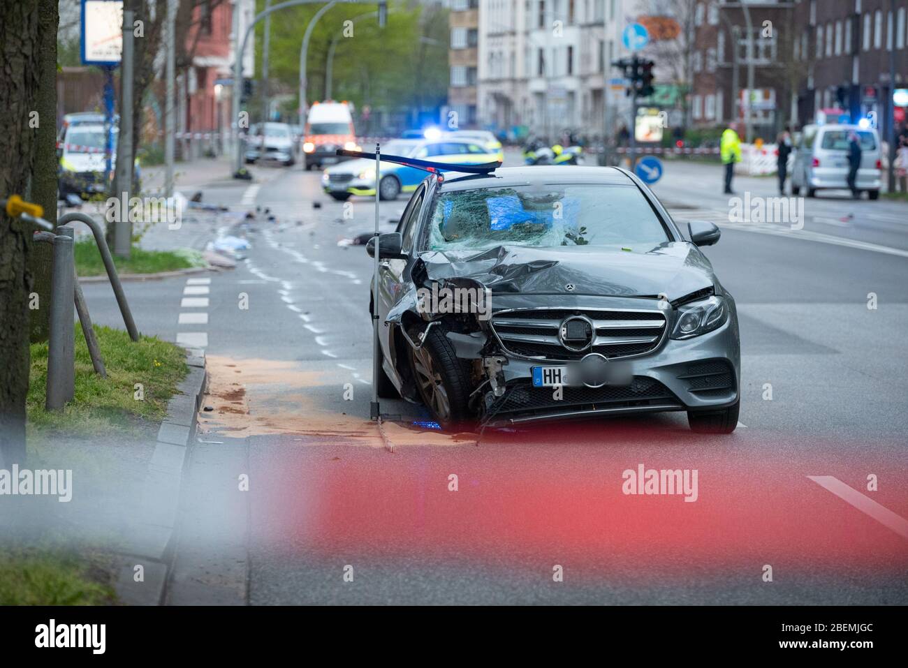 Hamburg, Germany. 14th Apr, 2020. The badly damaged Mercedes stands on the road after the accident. The vehicle had gone off the road in the Altona district, skidded into a traffic light and hit two people. The man and the woman suffered life-threatening injuries. The driver was 'apparently' intoxicated, according to a spokeswoman for the Hamburg Police Situation Center. Credit: Jonas Walzberg/dpa - ATTENTION: The license plate was pixelated for legal reasons/dpa/Alamy Live News Stock Photo