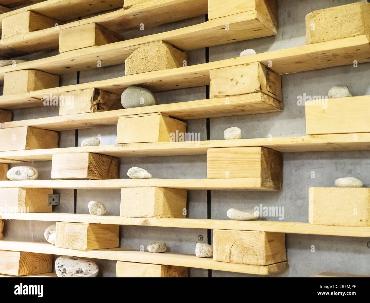 Decorative wooden shelves with pebbles of various sizes hanging on a