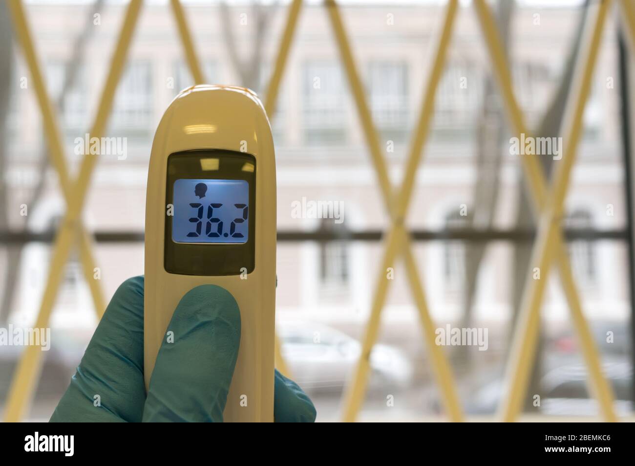 The doctor holds the infrared noncontact thermometer. The digital
