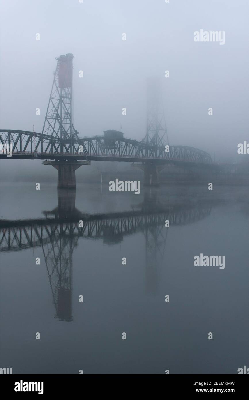 View of the Hawthorne lift bridge in thick fog on the Willamette River in downtown Portland, Oregon Stock Photo