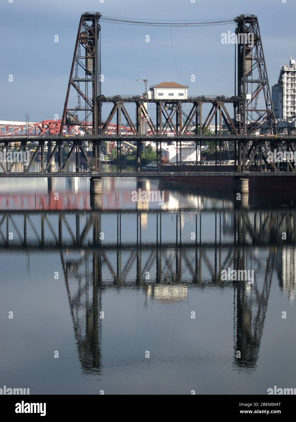 Reflections of the telescoping rail and road Steel Bridge over the Willamette River in Portland Oregon Stock Photo